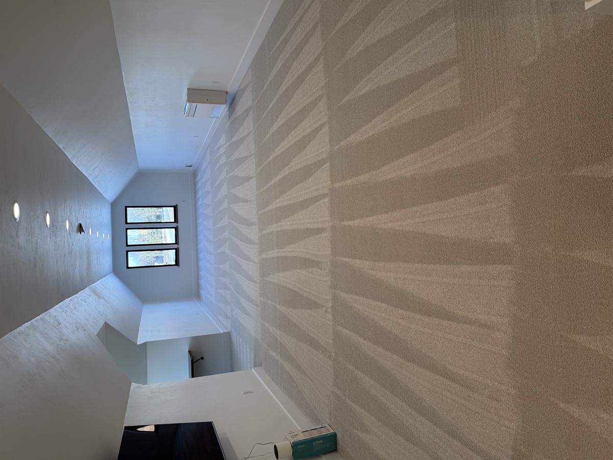 Bonus room carpet after cleaning — wide angle showing vaulted ceiling and recessed lighting