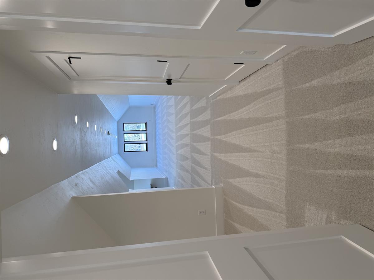 Upper hallway with white panel doors and freshly cleaned carpet leading to bonus room